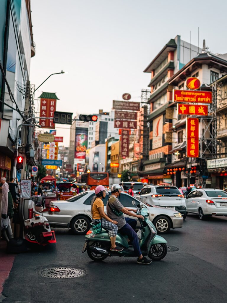 Lively night scene in Bangkok's Chinatown showcasing bustling street life and vibrant signs.